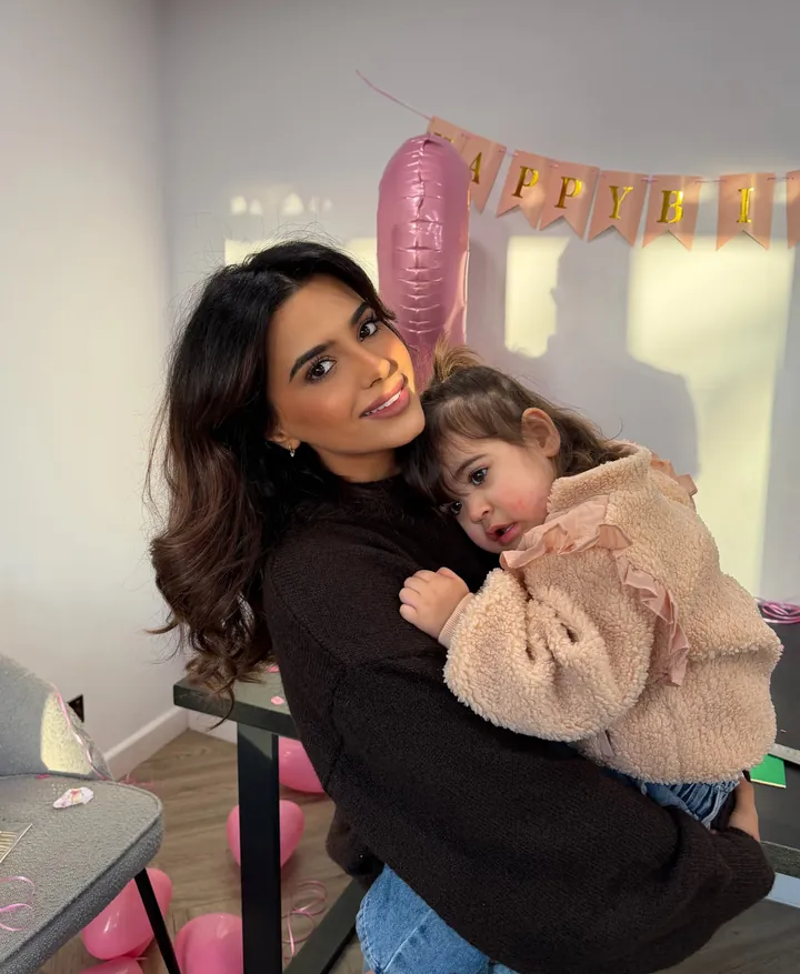 Cheri cuddling her daughter at a birthday party