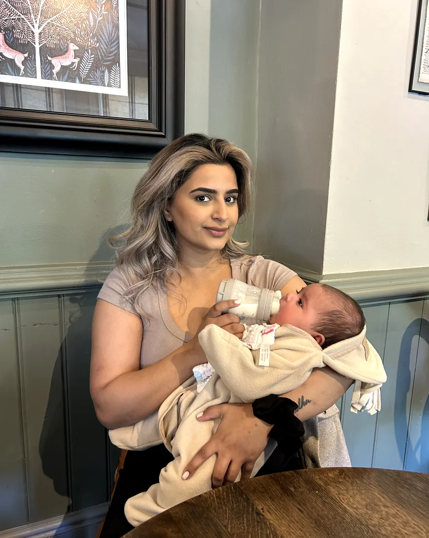 Cheri feeding her newborn baby